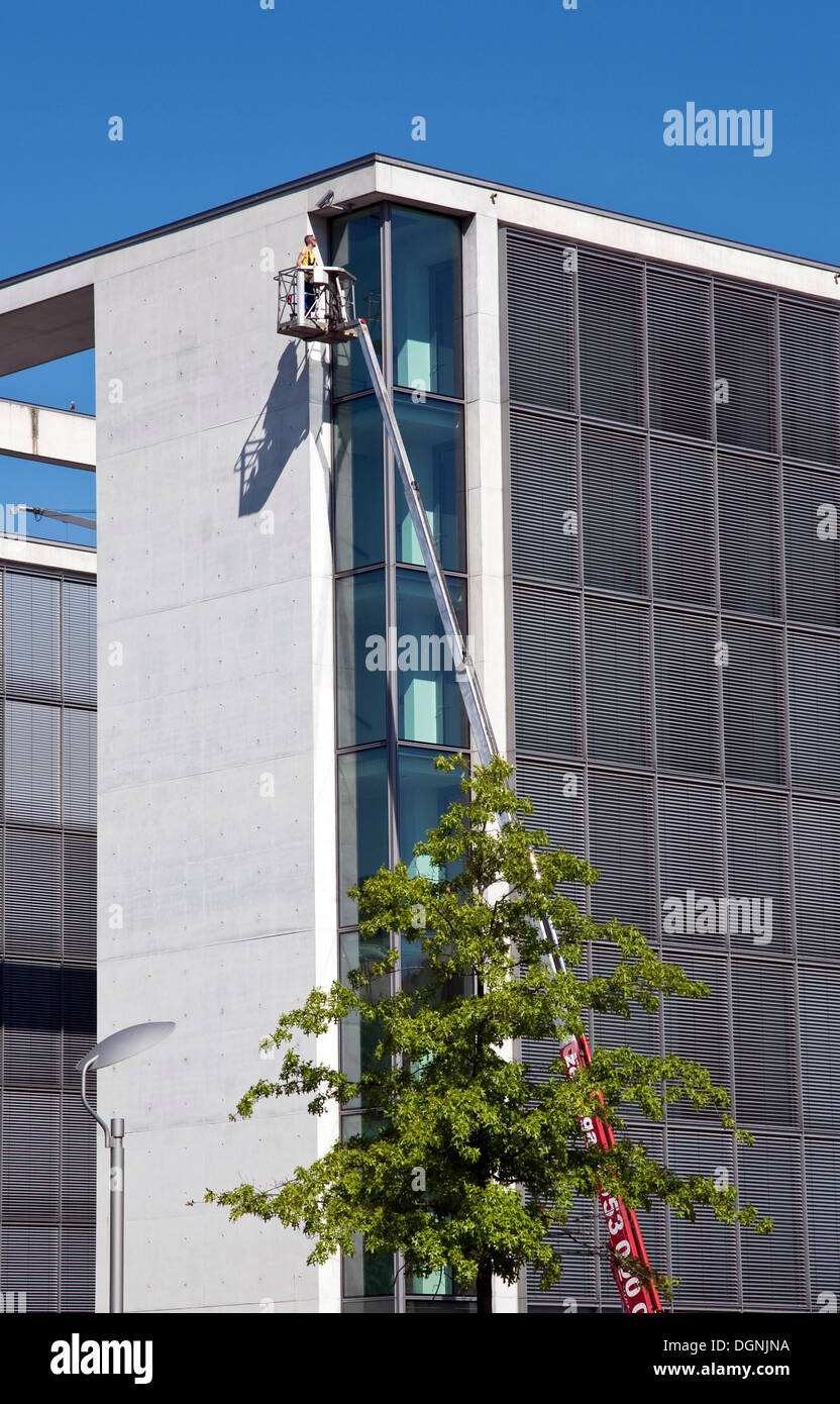 Workman working on the facade of an office complex in the Regierungsviertel government district, Berlin Stock Photo