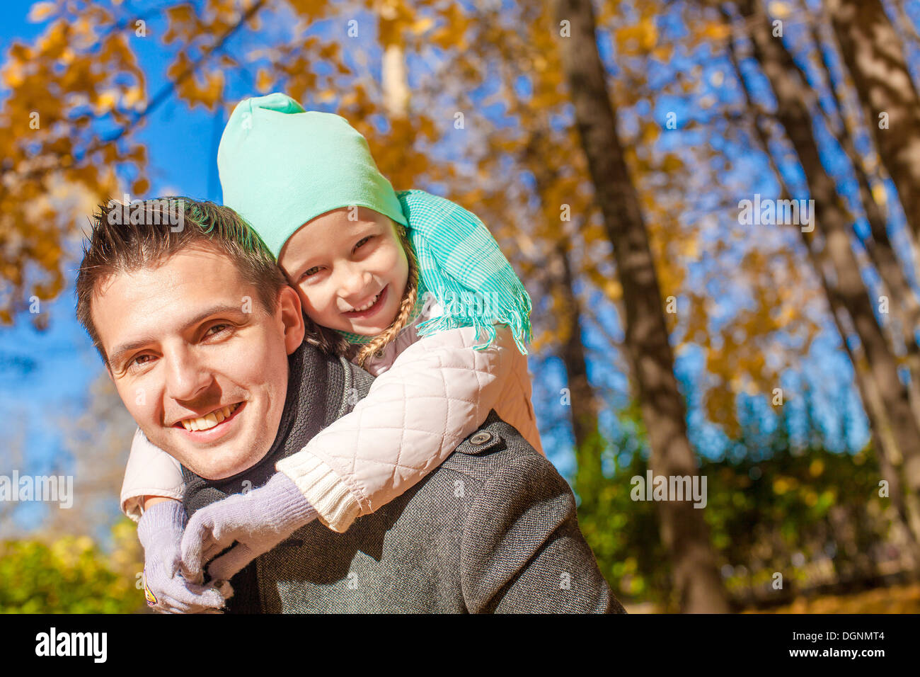 Portrait of happy father walking with his cute daughter in autumn park ...