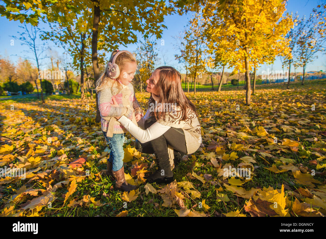 Little adorable girl and young mother in autumn park on sunny day Stock ...