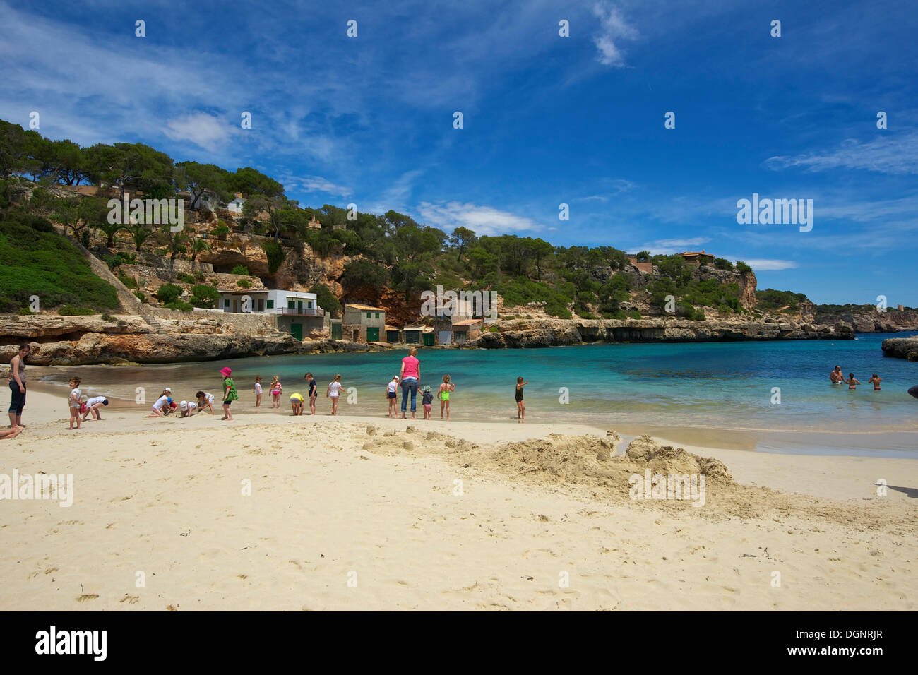 Tourists on the beach in the bay at Cala Llombards, Cala Llombards