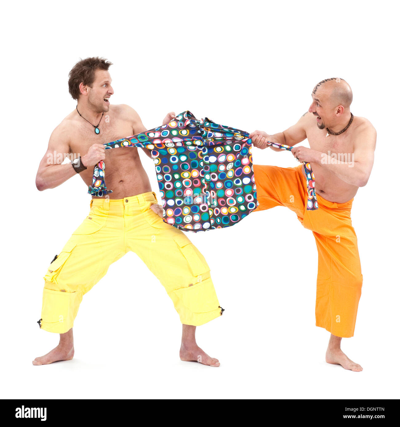 Two men pulling on a colorful shirt Stock Photo