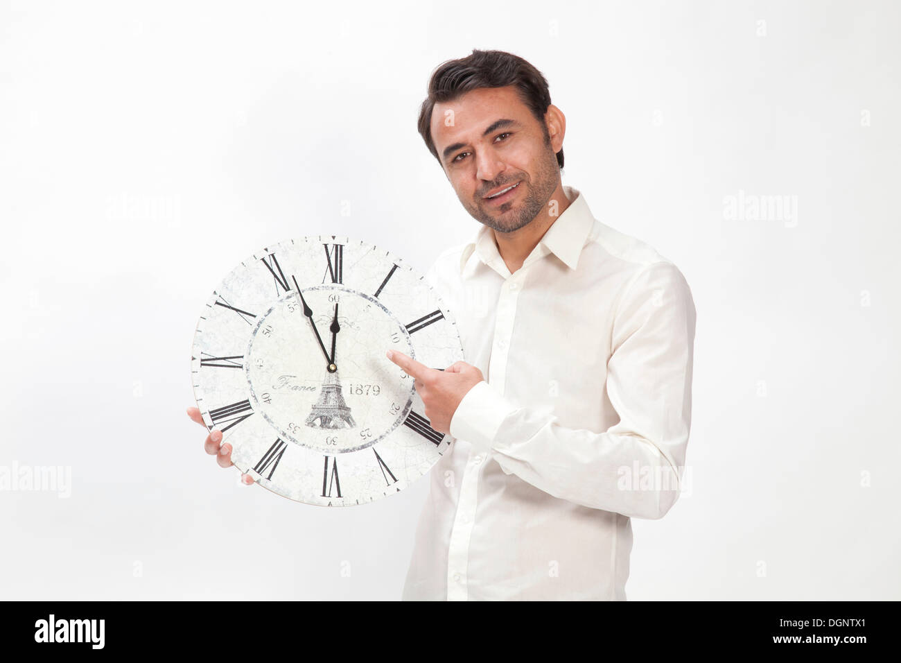 Man holding a clock at eleven fifty-five, almost high noon Stock Photo ...