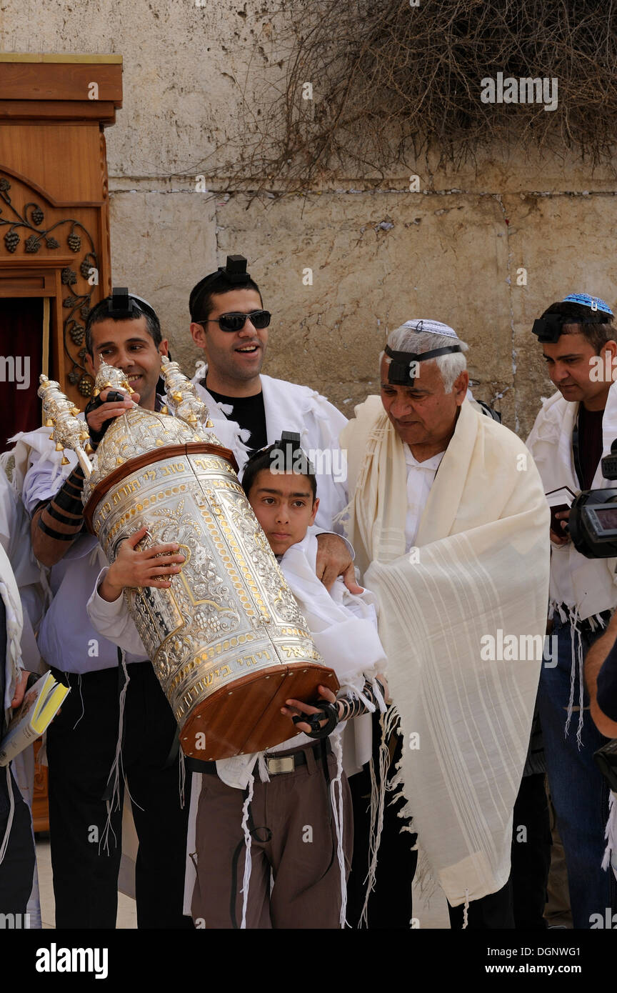 Jewish boy carrying the Torah scroll from the shrine at the Wailing Wall, Western Wall, to a table, Bar Mitzvah celebration Stock Photo
