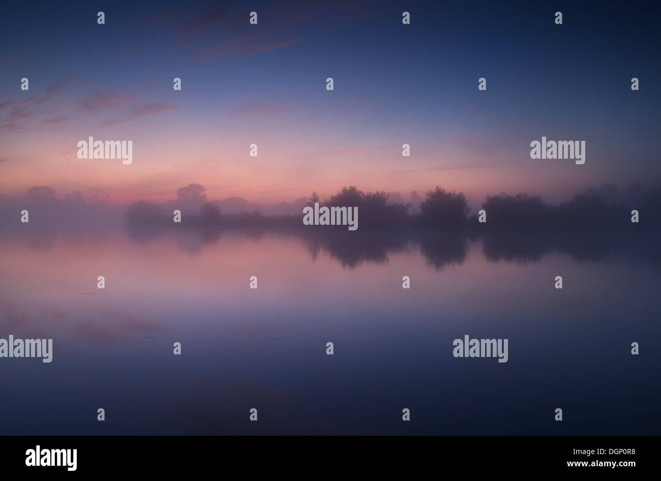 tranquil misty sunrise on wild lake, Drenthe, Netherlands Stock Photo