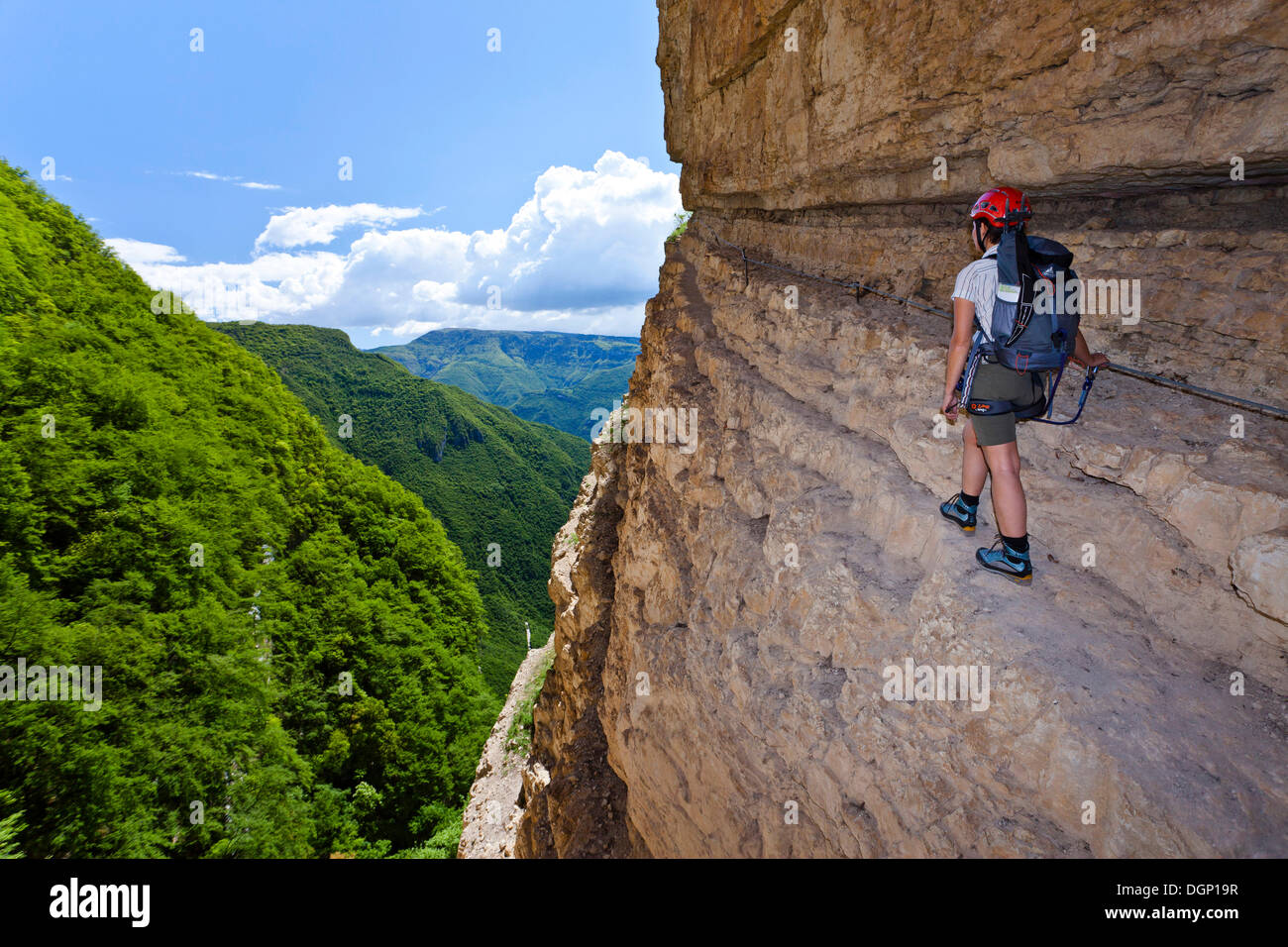 Rock climber climbing on the Gerardo Sega fixed rope route on Monte Baldo mountain above Avio, Lake Garda region Stock Photo
