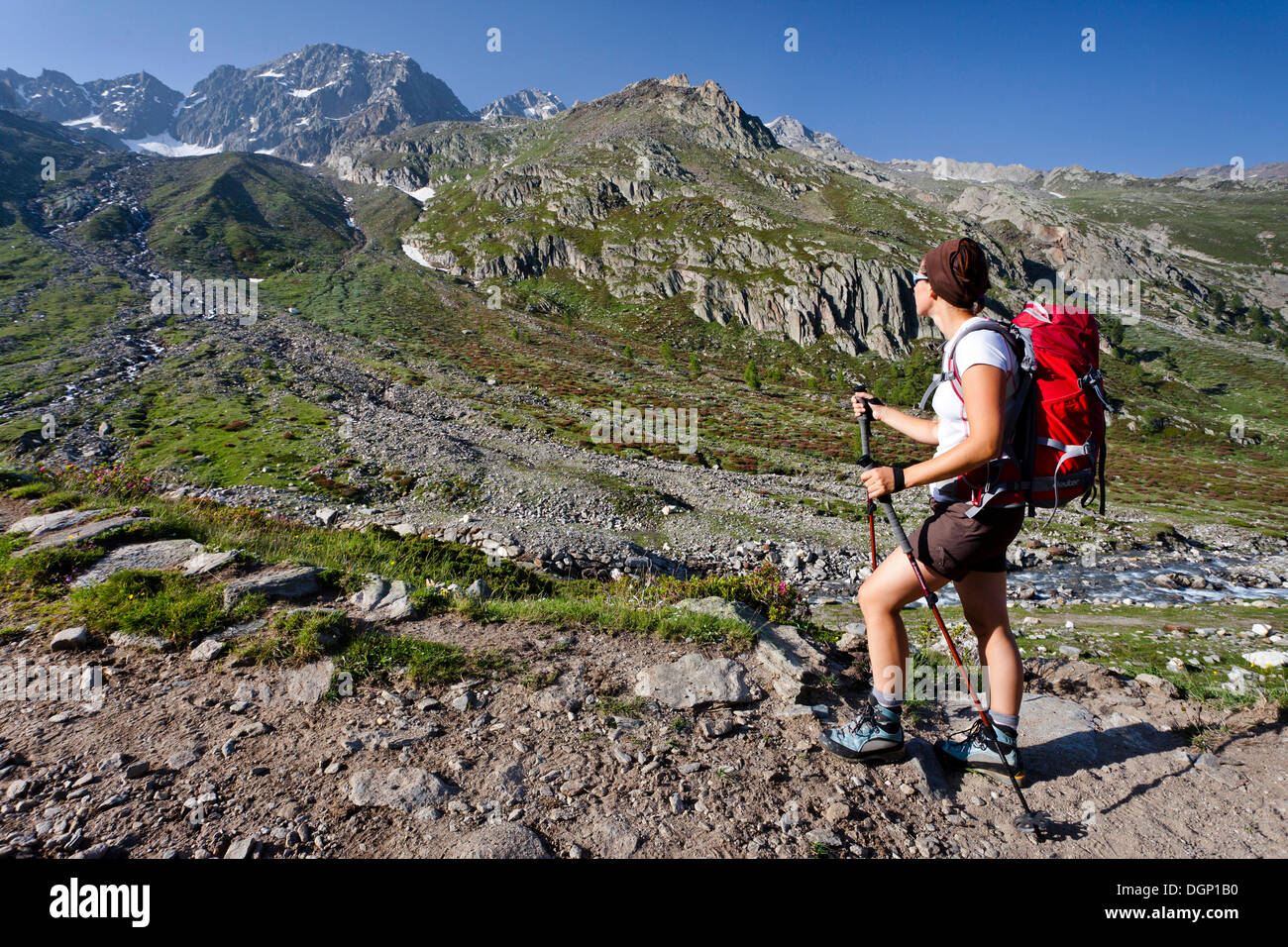 Hiker walking on the Merano High Mountain Trail, view during the ascent to Hohe Wilde mountain in the Pfossental valley Stock Photo