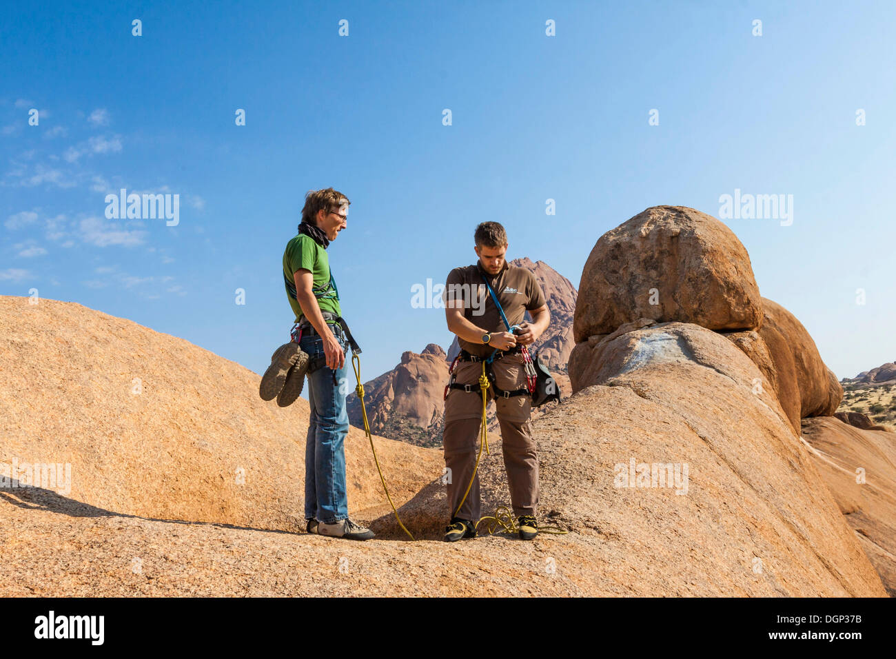 Two young climbers at Bogenfels, Spitzkoppe, Namibia, Africa Stock Photo