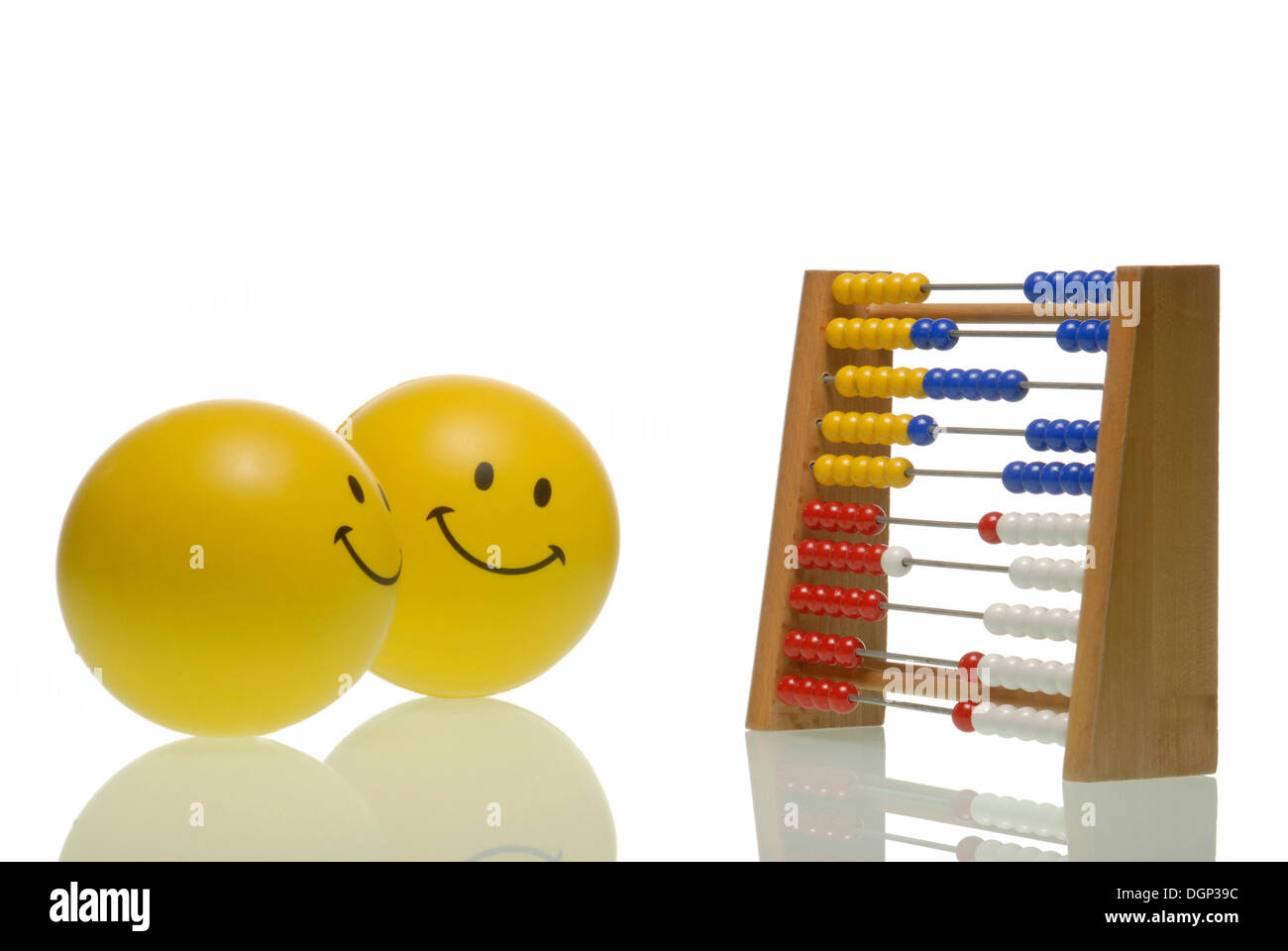 A smiley coaching another with an abacus, symbolic image for coaching Stock Photo