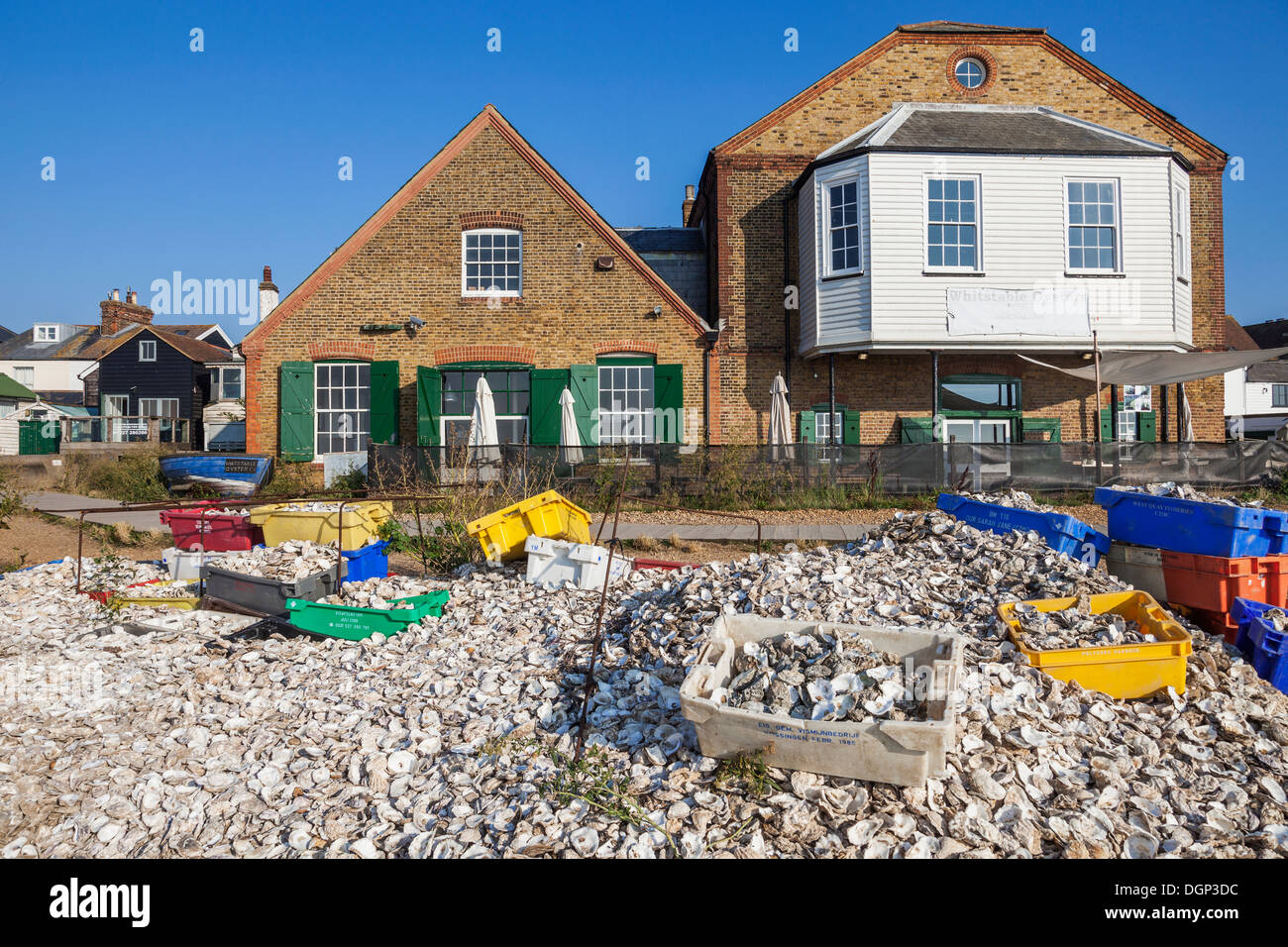 England, Kent, Whitstable, Piles of Oyster Shells and Waterfront Buildings Stock Photo