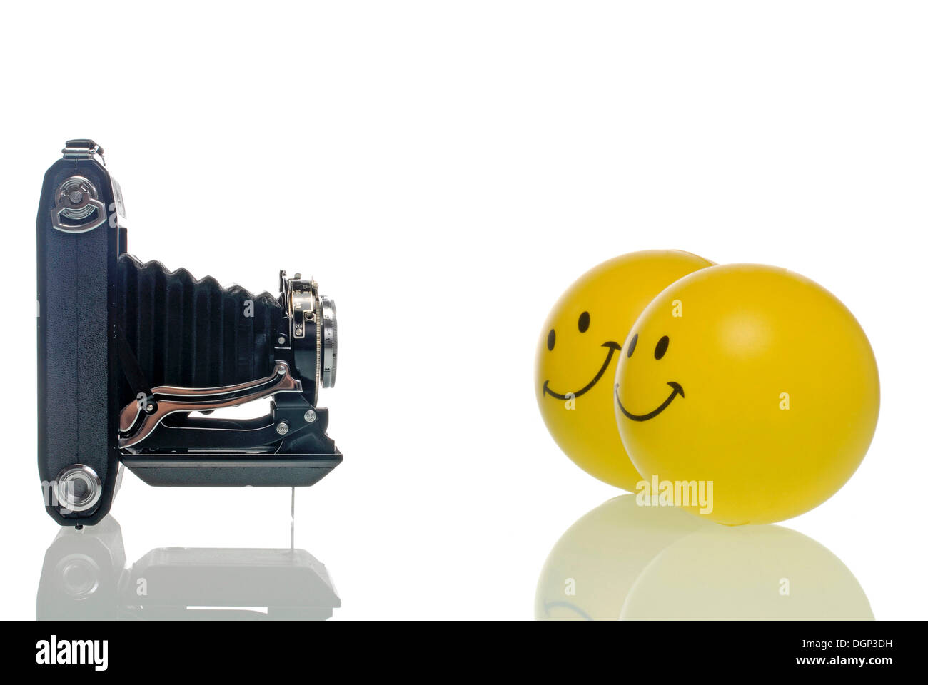 Two smileys looking into a camera, symbolic image for photography Stock Photo