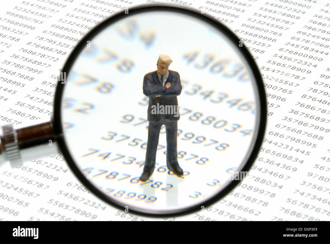 Business man figure on a number background under a magnifying glass ...