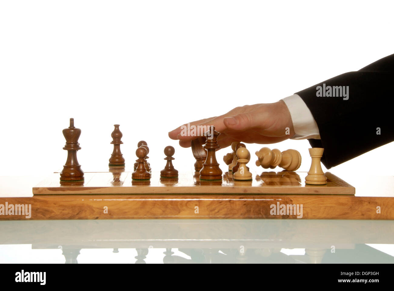 Businessman throwing chess figures around after losing game Stock Photo