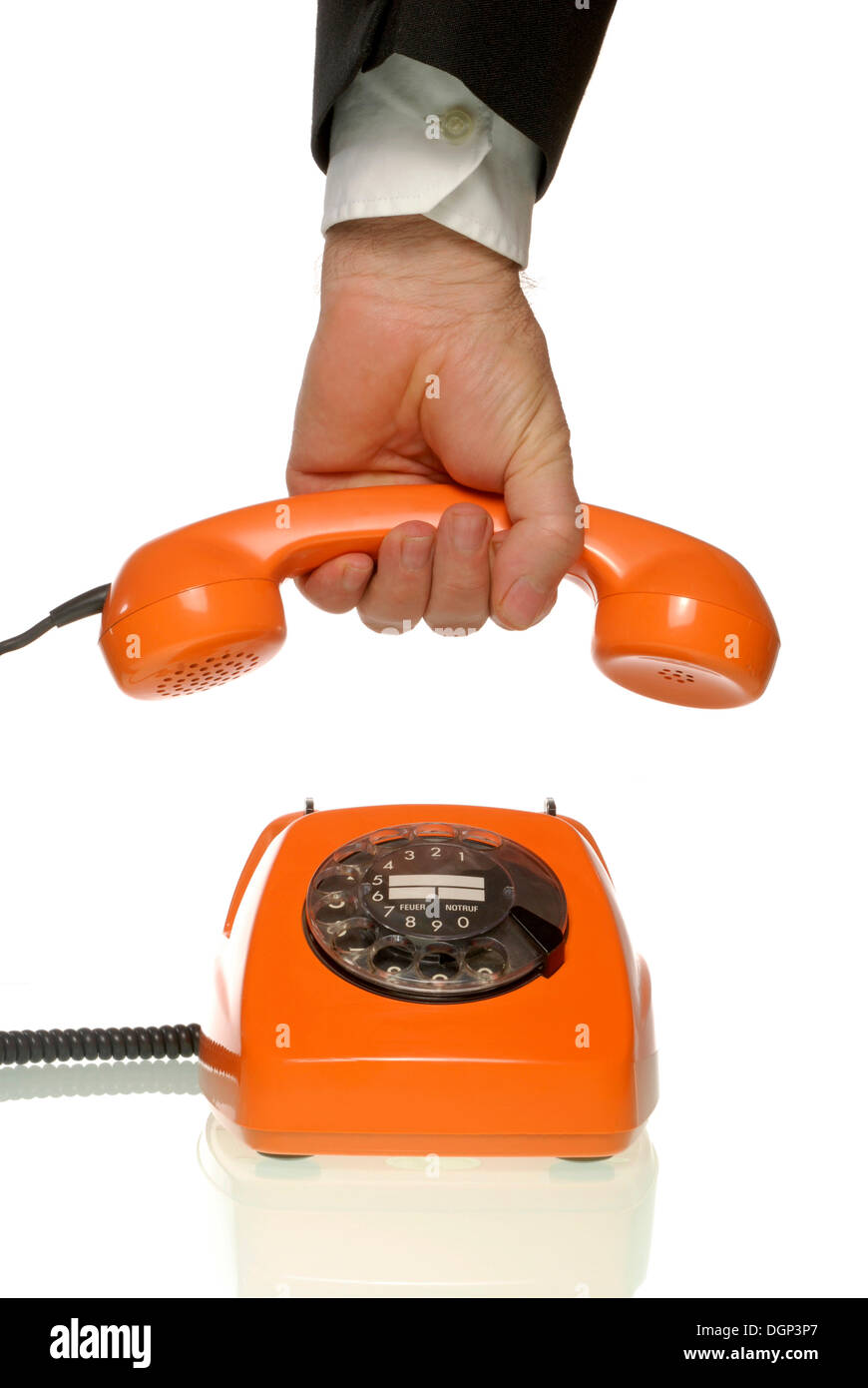 Business man holding the receiver of an orange telephone Stock Photo