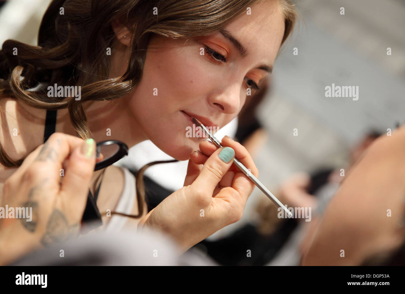Berlin, Germany, makeup is applied in the models at Fashion Week Stock