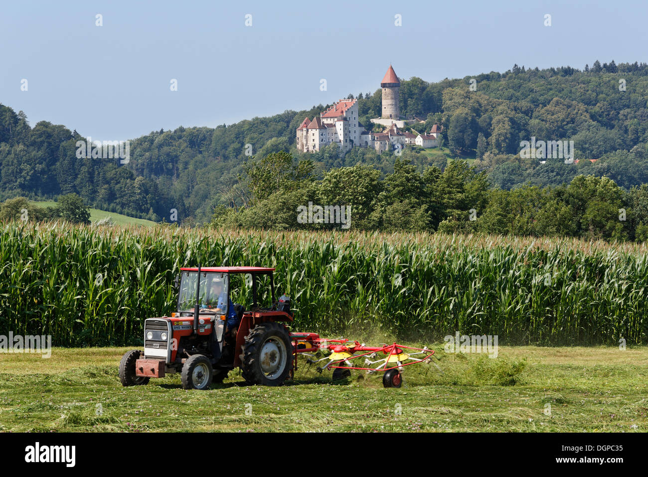 Tractor with tedder in front of Burg Clam Castle, Klam, Muehlviertel region, Upper Austria, Austria, Europe, PublicGround Stock Photo