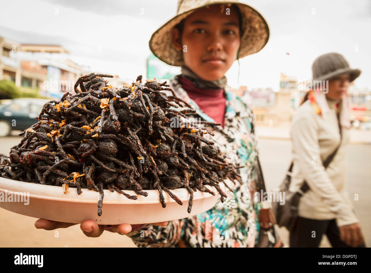 Cambodia, Woman selling fried tarantula spiders Stock Photo