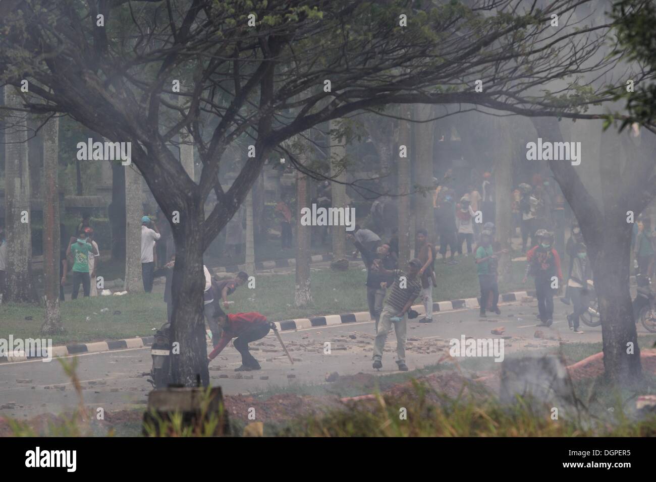 Batam, Indonesia. 23rd Oct, 2013. Protestors throw stones towards ...