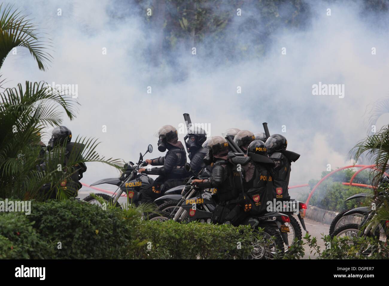 Batam, Indonesia. 23rd Oct, 2013. Police defend and repel demonstrators ...