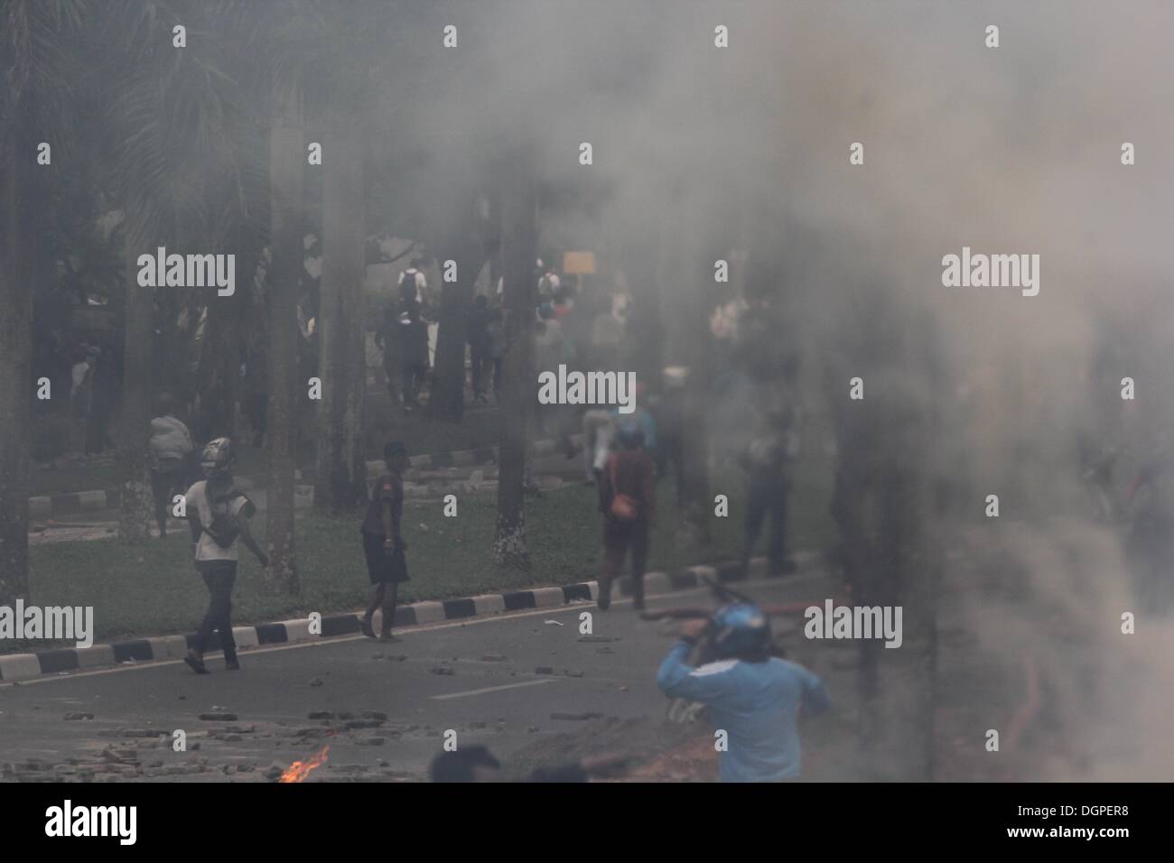 Batam, Indonesia. 23rd Oct, 2013. Protestors throw stones towards ...