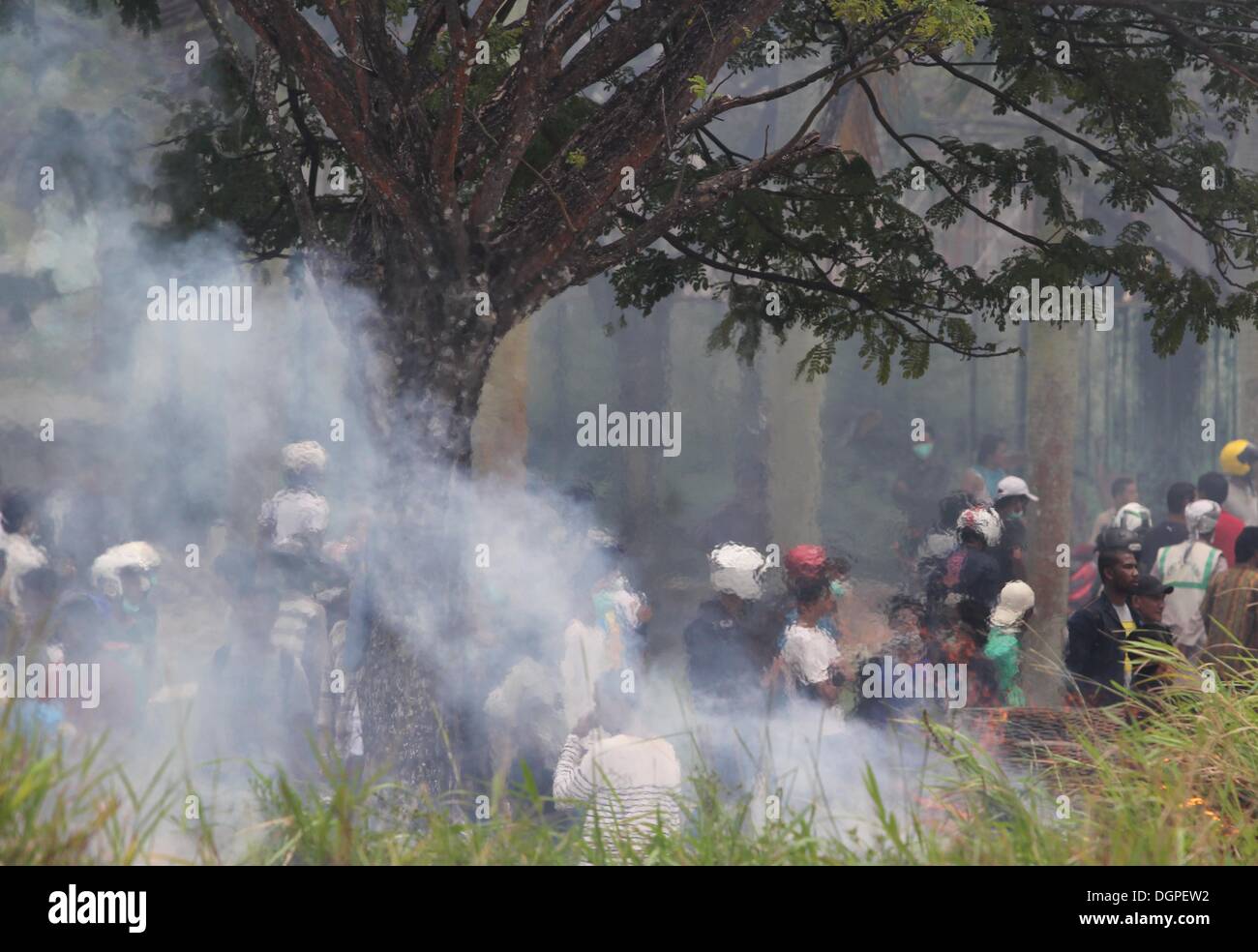 Batam, Indonesia. 23rd Oct, 2013. Protestors throw stones towards ...