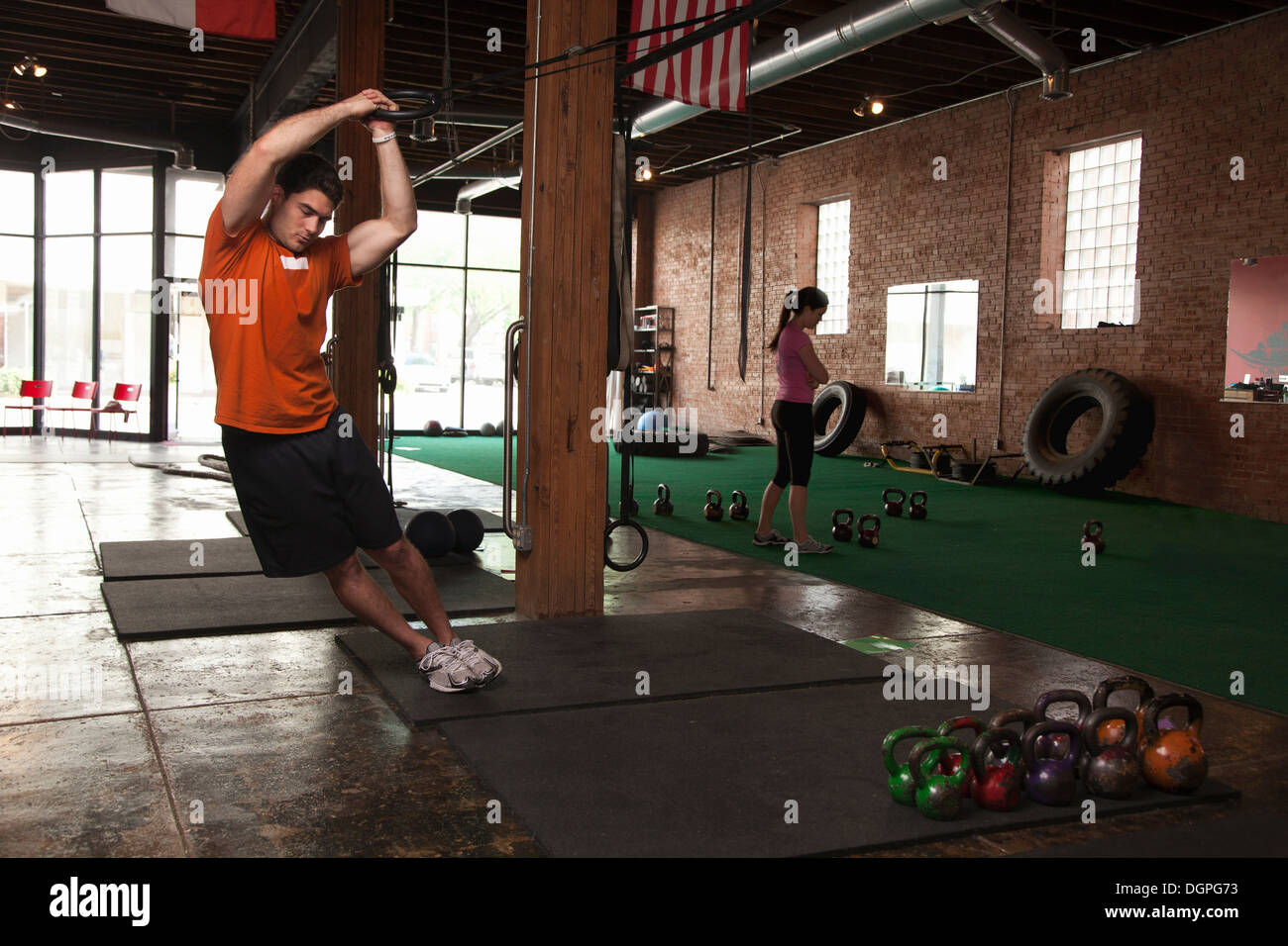 Bodybuilder using rings in gym Stock Photo Alamy