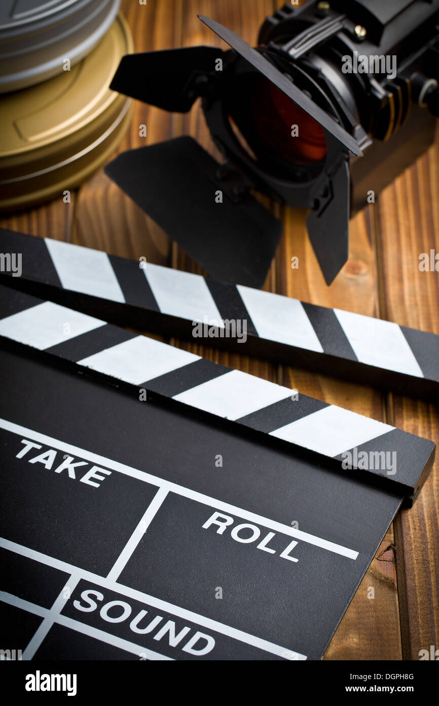 clapper board with movie light on wooden table Stock Photo