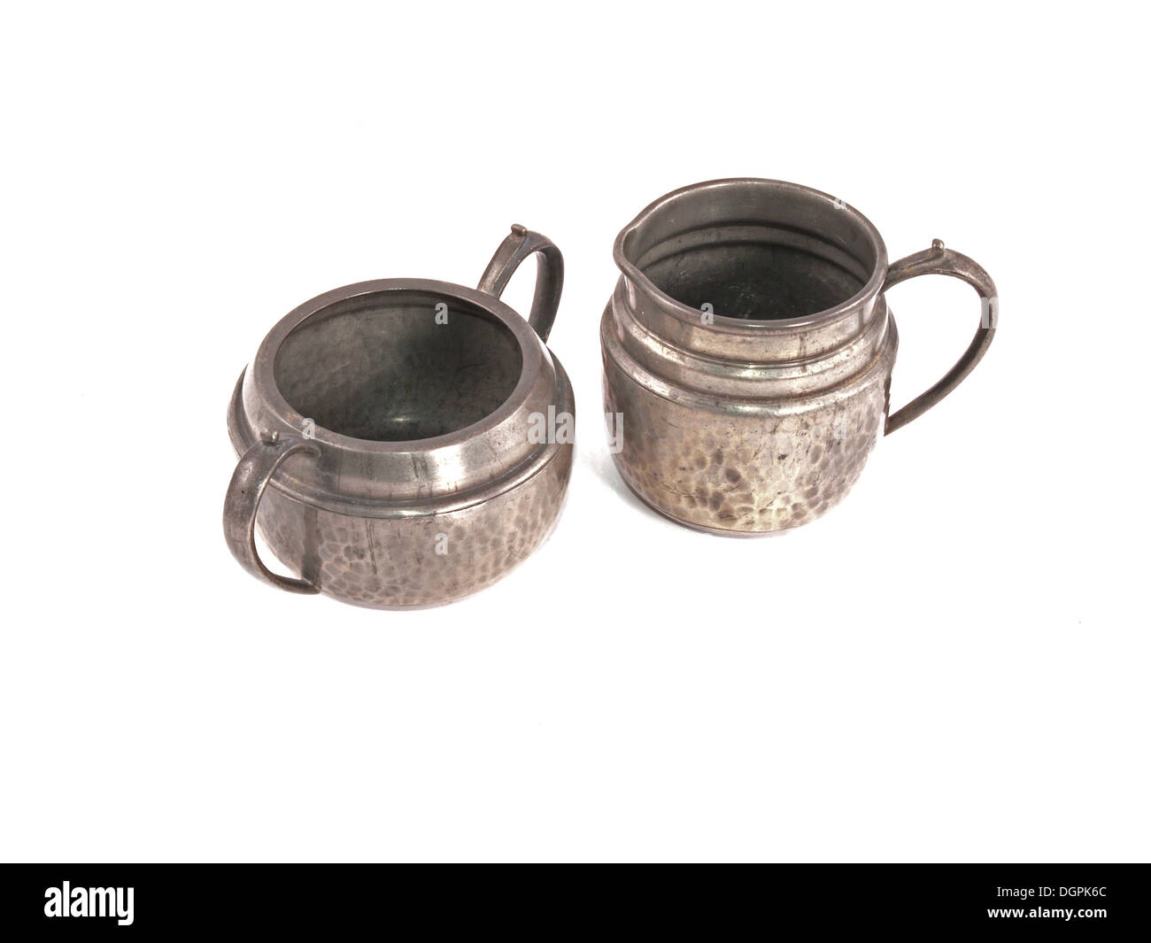 Pewter sugar bowl and milk jug on a white background. Stock Photo