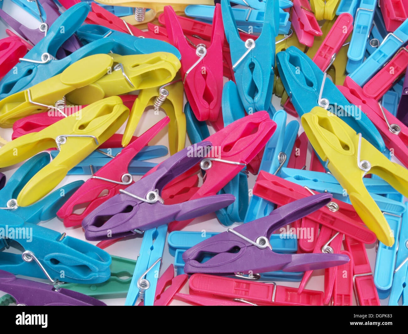 Close up of multicoloured plastic clothes pegs. Stock Photo