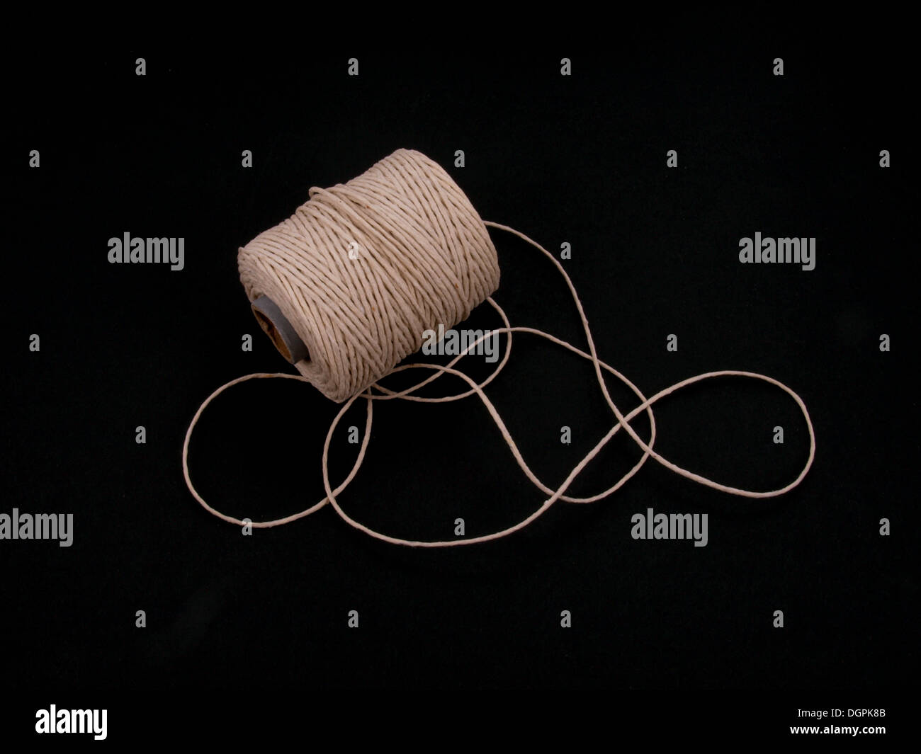 Ball of string or twine on a plain black background. Stock Photo