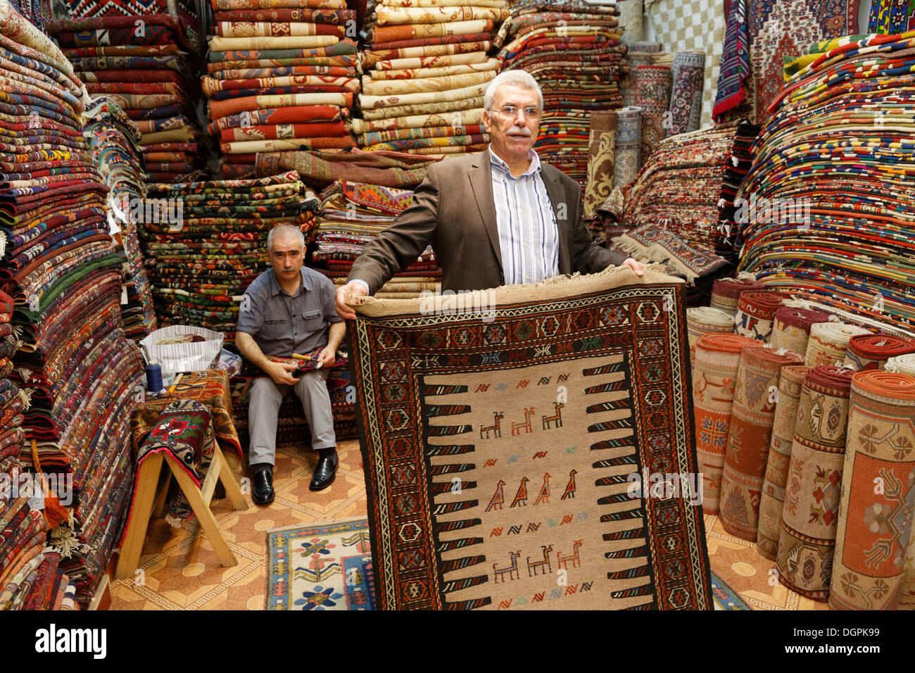 Men in a carpet dealer's store, Kemeralti, Izmir, İzmir Province, Aegean Region, Turkey Stock Photo