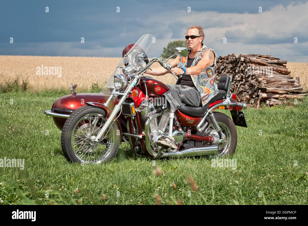 Man with a prosthetic leg riding a motorbike with a side car, chopper ...