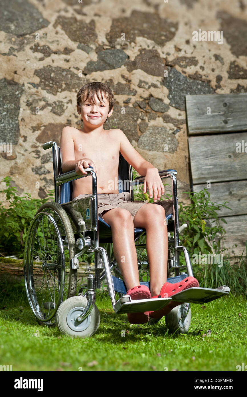 Boy sitting in a wheelchair Stock Photo