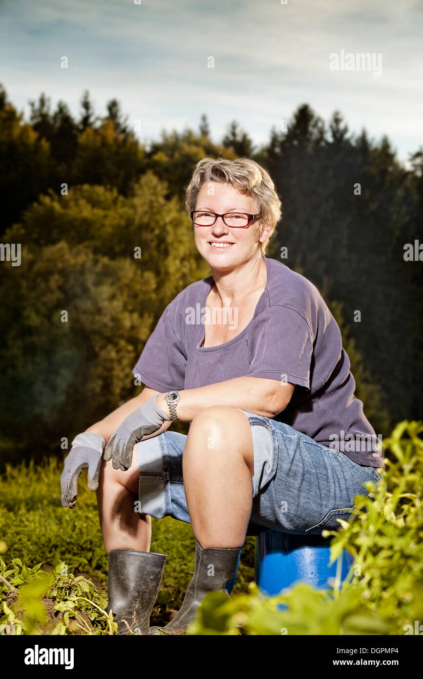 Woman working on a field Stock Photo