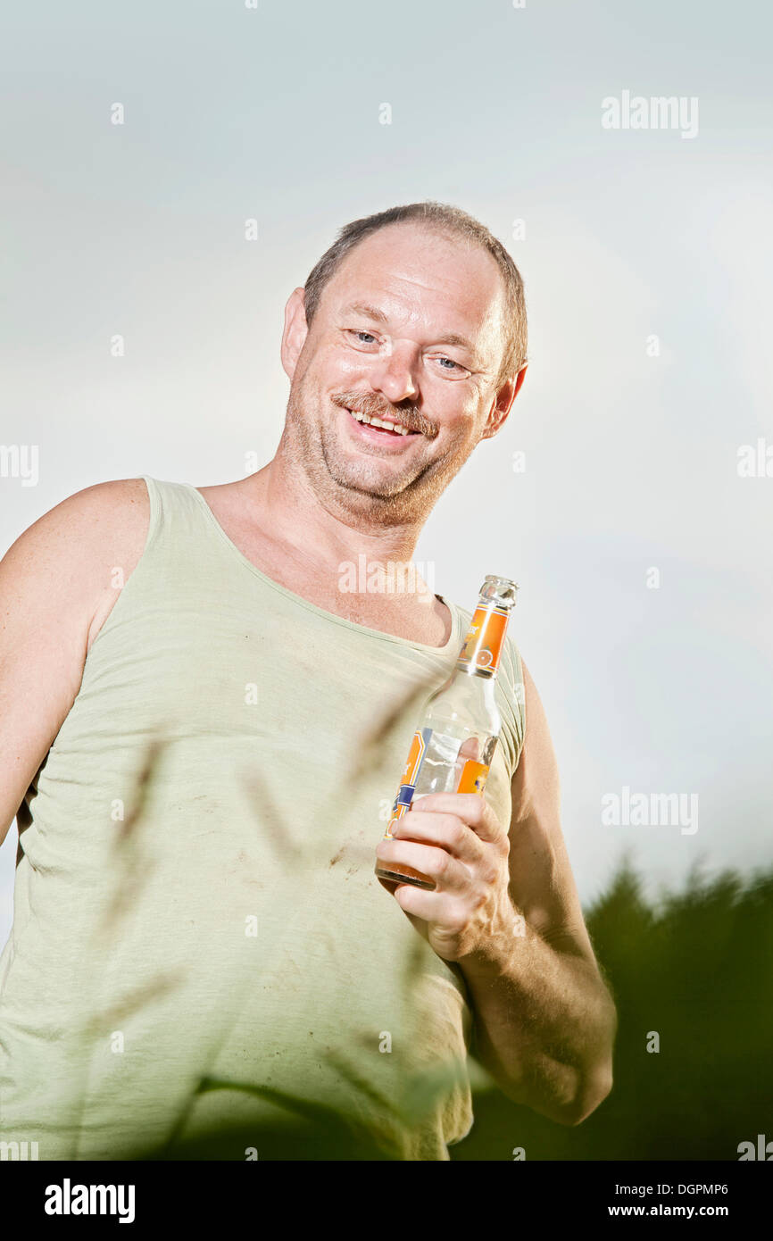Man holding a soft drink bottle Stock Photo