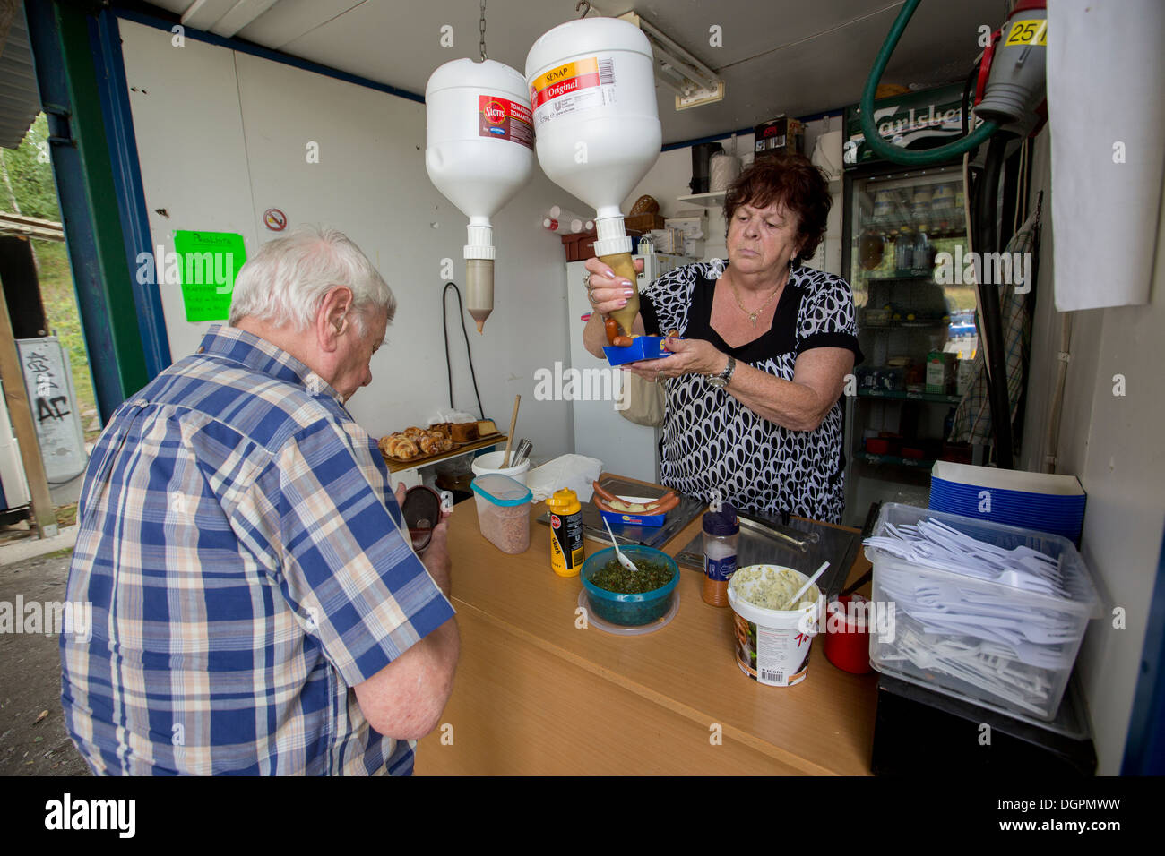 Customers served sausages from a hot dog stand Stock Photo Alamy