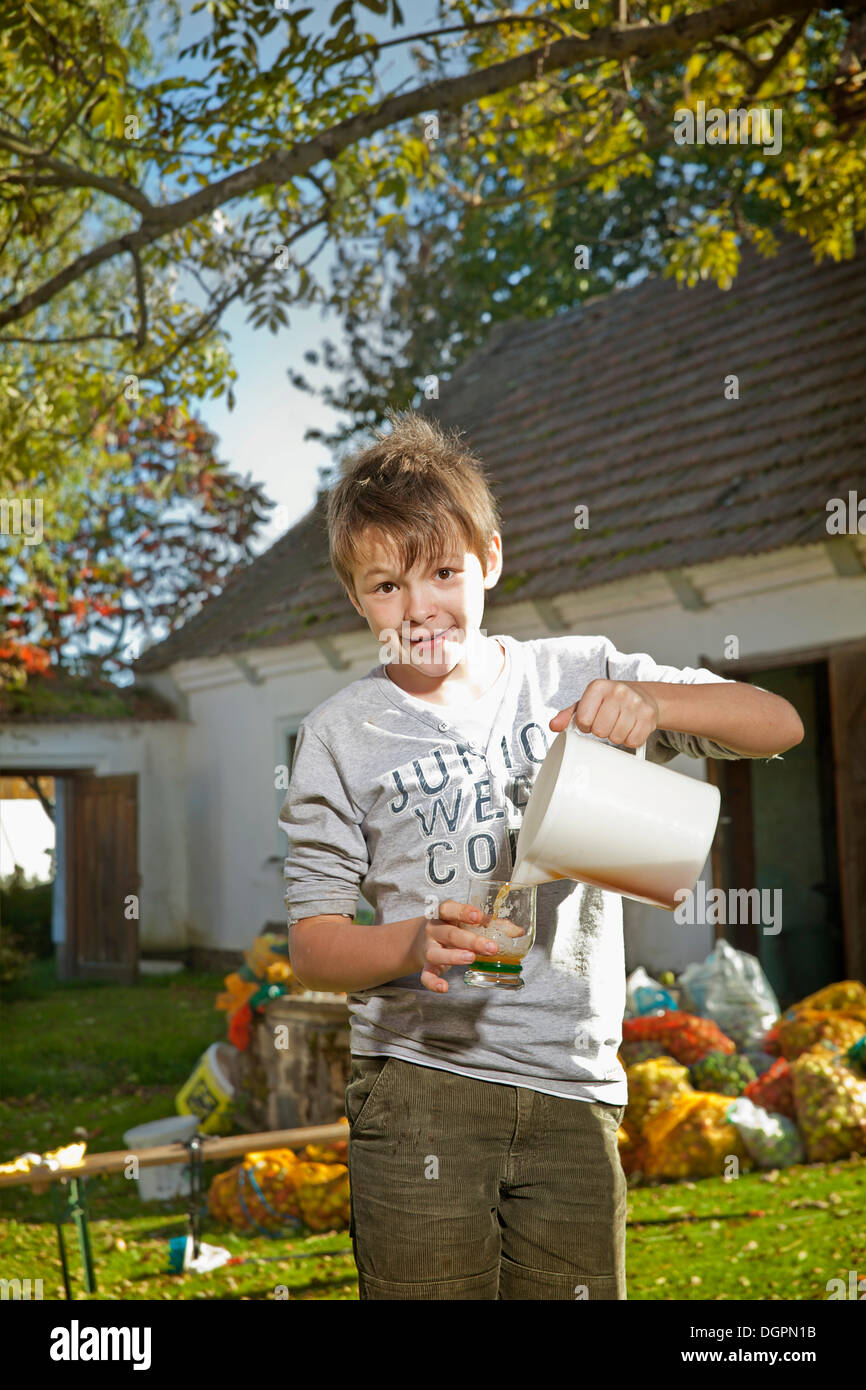 Boy with freshly squeezed apple juice Stock Photo