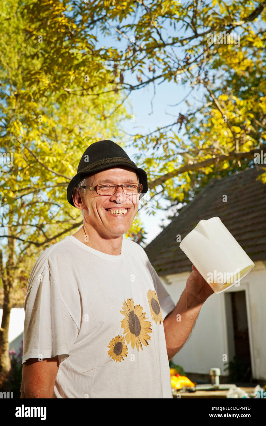 Man with freshly squeezed apple juice Stock Photo