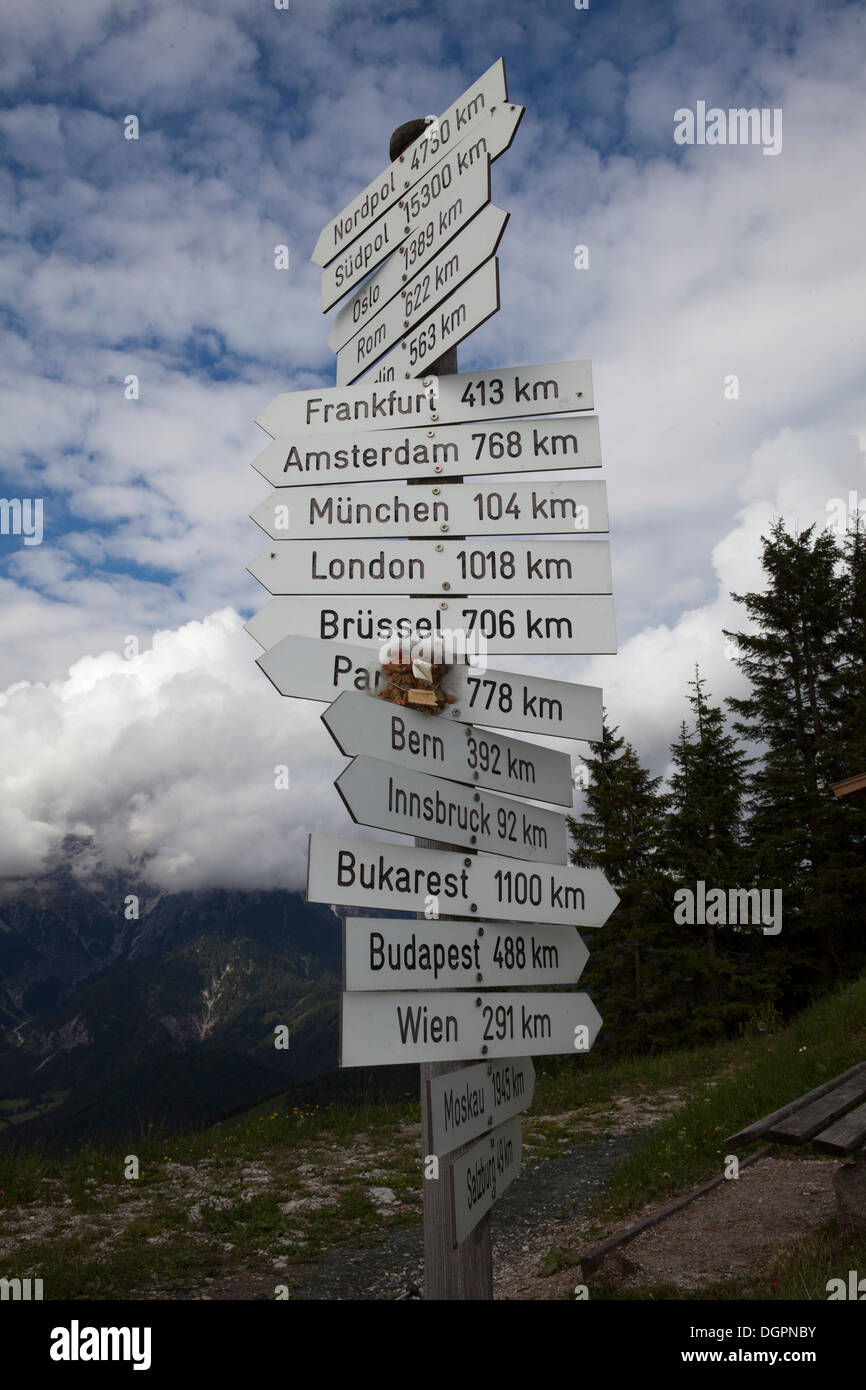 Signpost showing distances to various international cities near the summit of Buchensteinwand Mountain, Tyrol, Austria, Europe Stock Photo