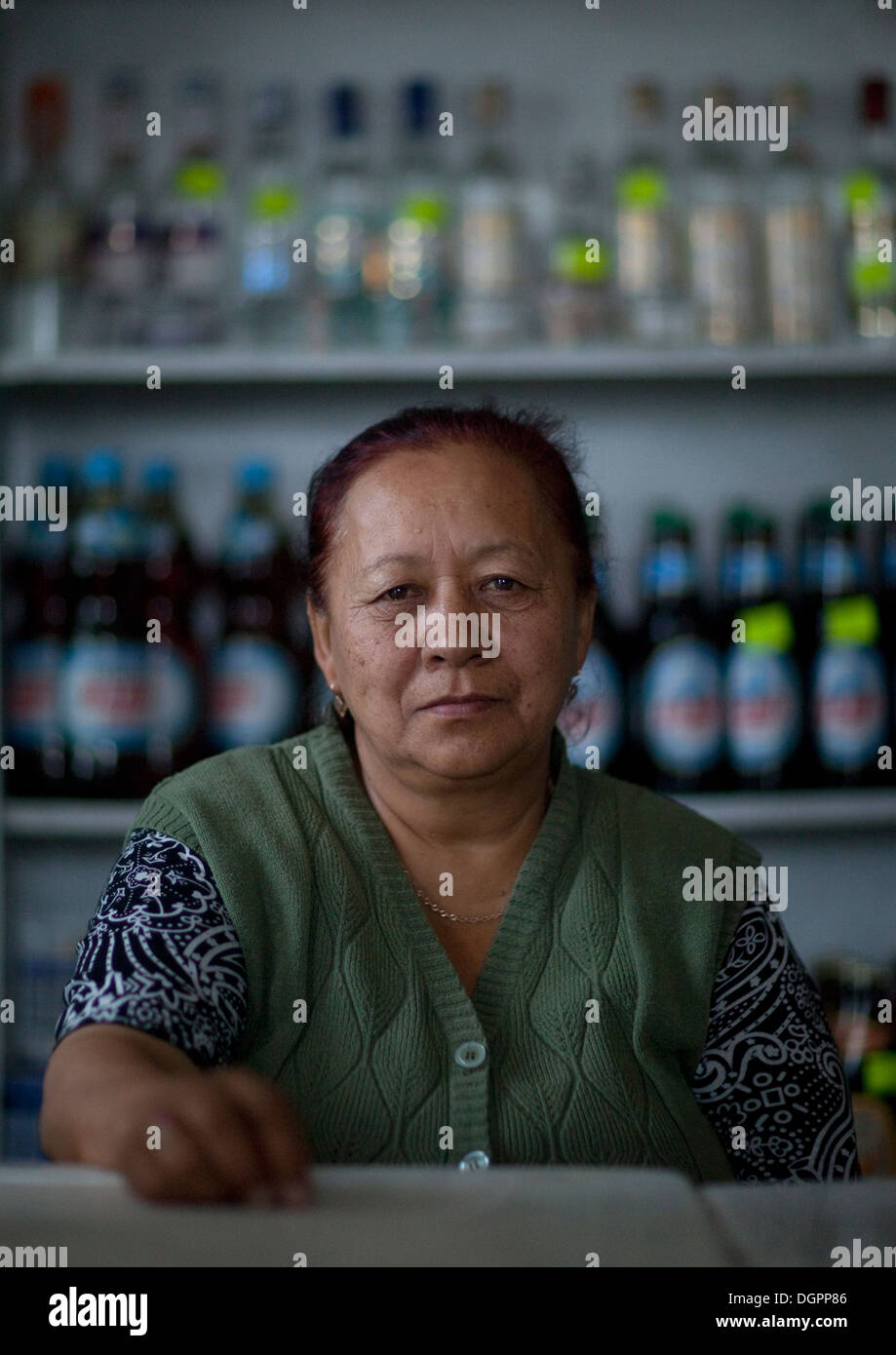 Old Woman Behind The Counter Of Her Store, Kochkor, Kyrgyzstan Stock