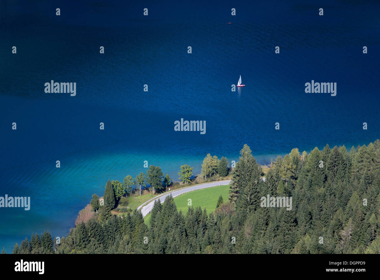 View over the deep blue and clear waters of Weissensee lake, a mountain lake with drinking quality water, Carinthia, Austria Stock Photo