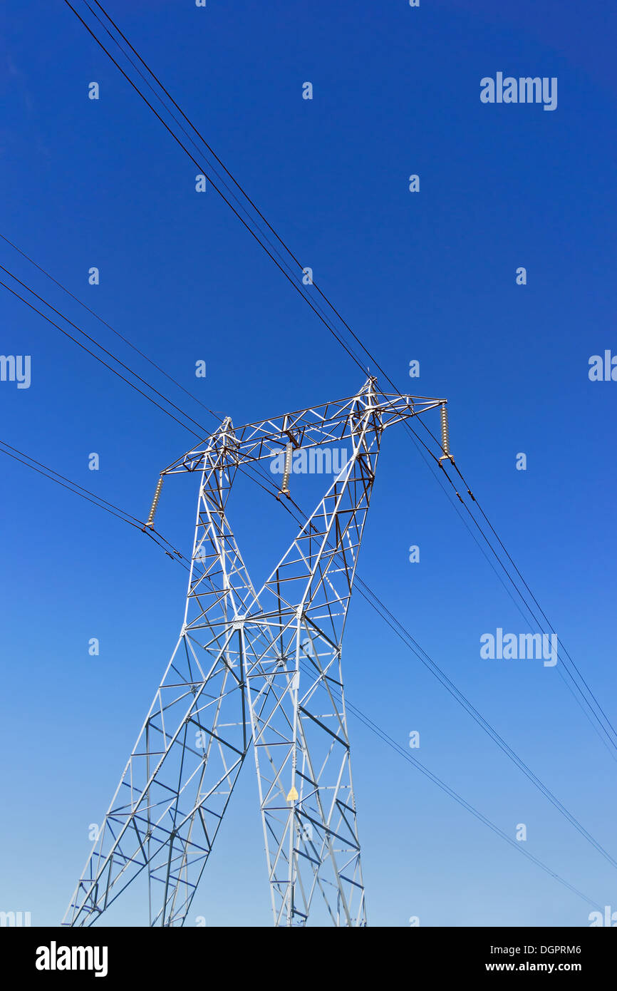 High voltage transmission tower against blue sky Stock Photo - Alamy