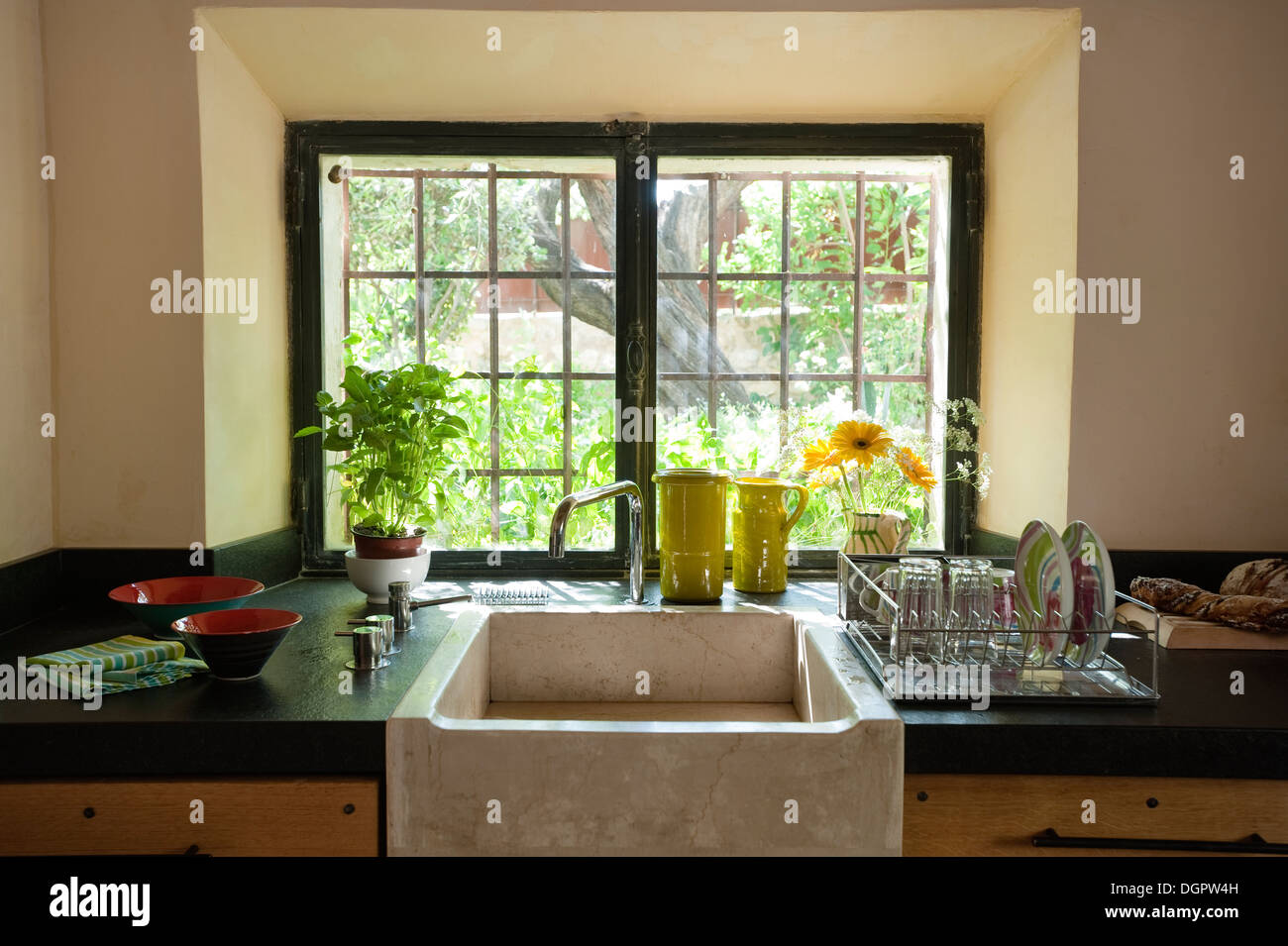 A Stone Farm Sink In Front Of An Old Paned Window Stock