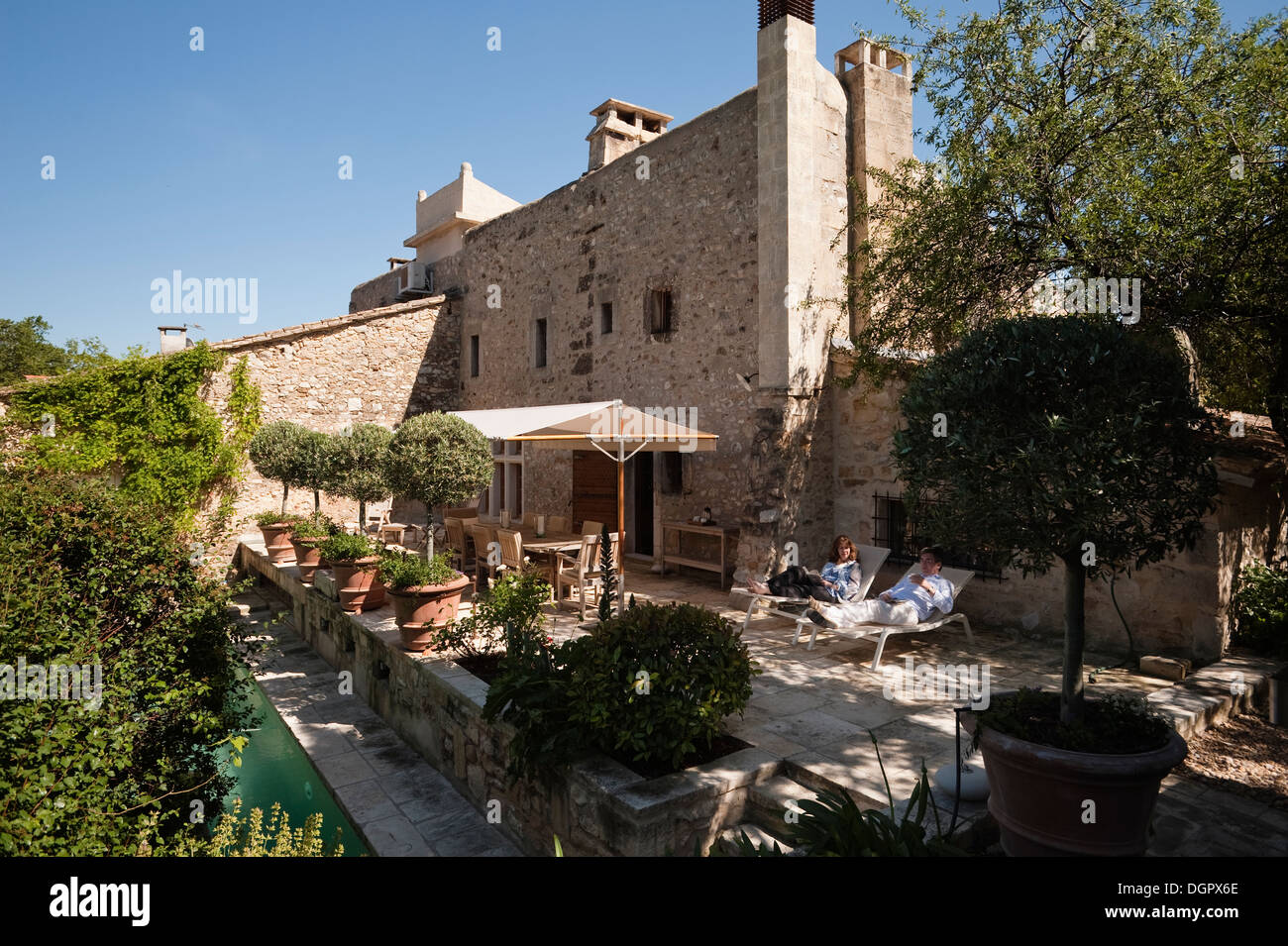 Exterior facade of a Provençal house with pool terrace and sun shade Stock Photo