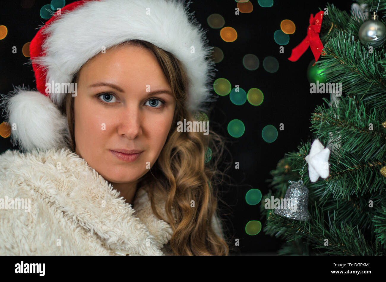Attractive woman over christmas tree. Stock Photo