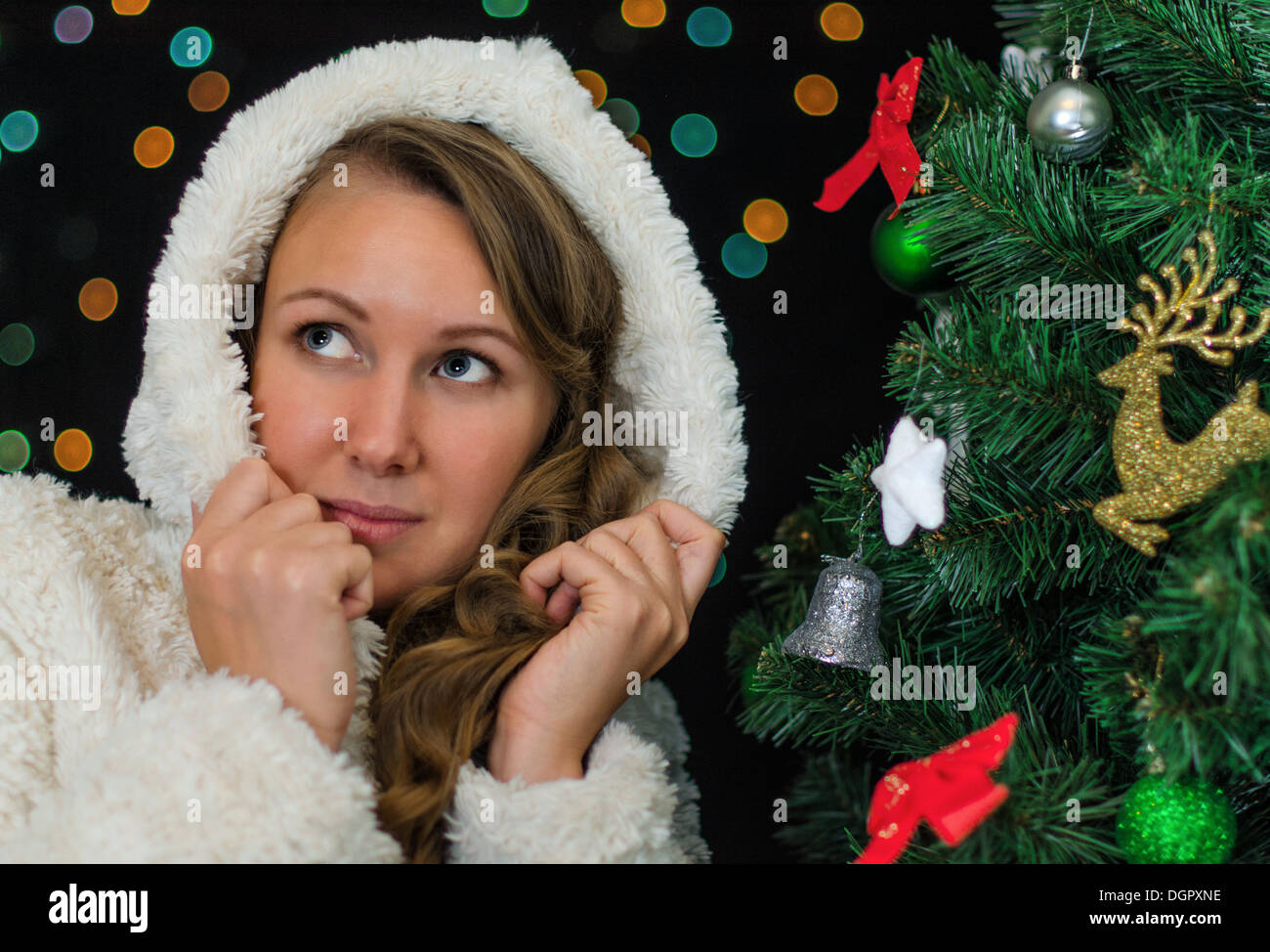 Attractive woman over christmas tree. Stock Photo
