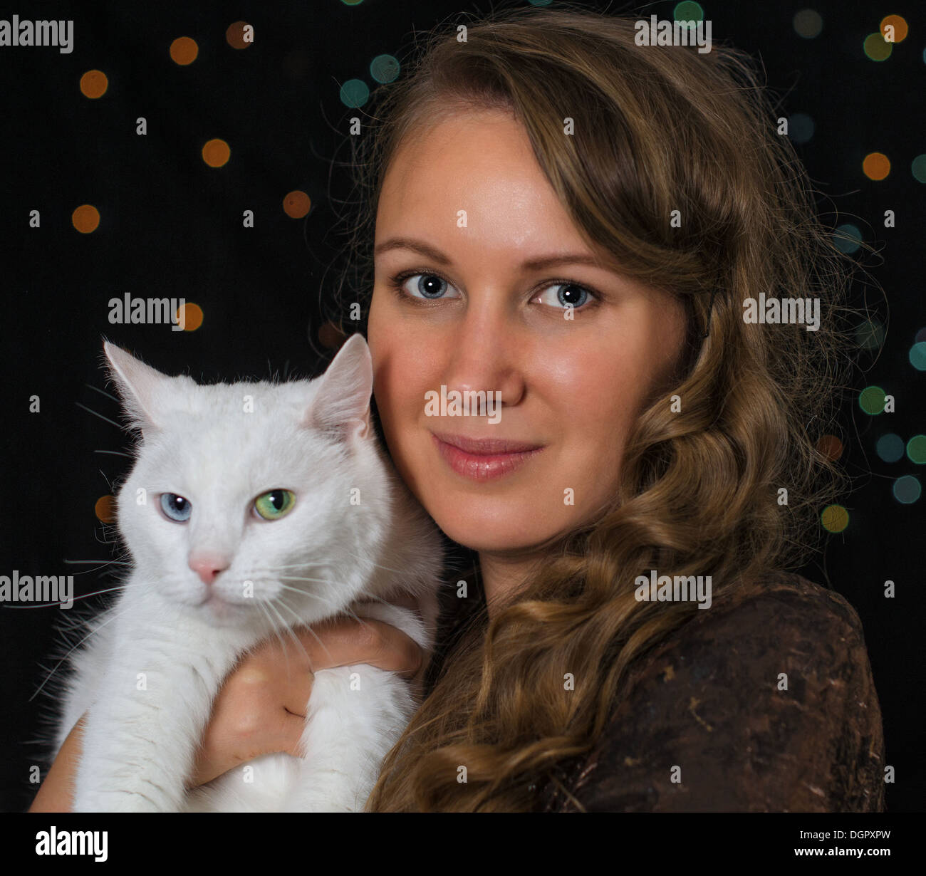 Woman and white cat portrait over bokeh Stock Photo