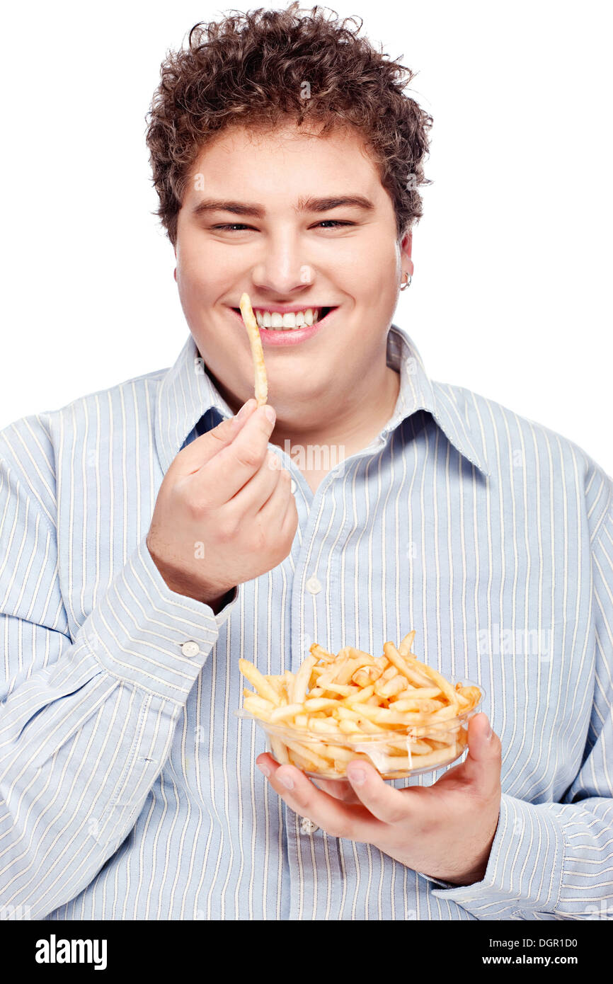 Happy young chubby man with french fries in dish, isolate on white Stock Photo
