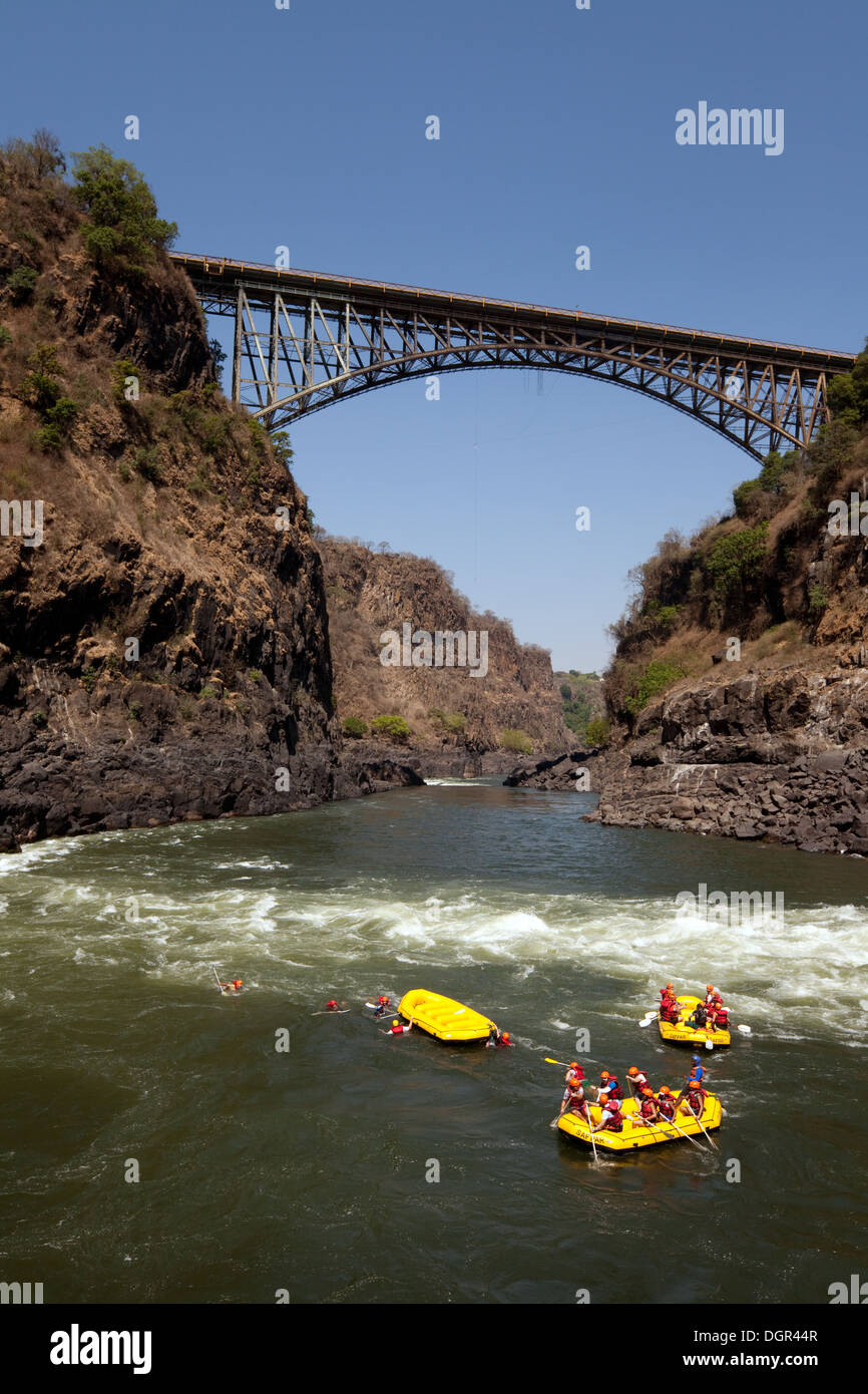 Adventure travel, people white water rafting on the Zambezi River at the Victoria Falls Bridge, Zambia, Africa Stock Photo
