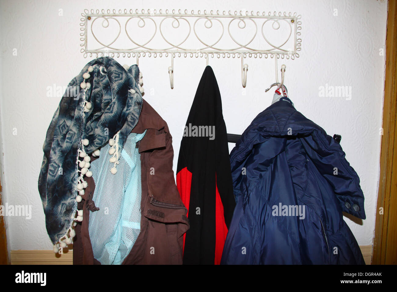 Jackets hanging on coat hook in hallway Stock Photo