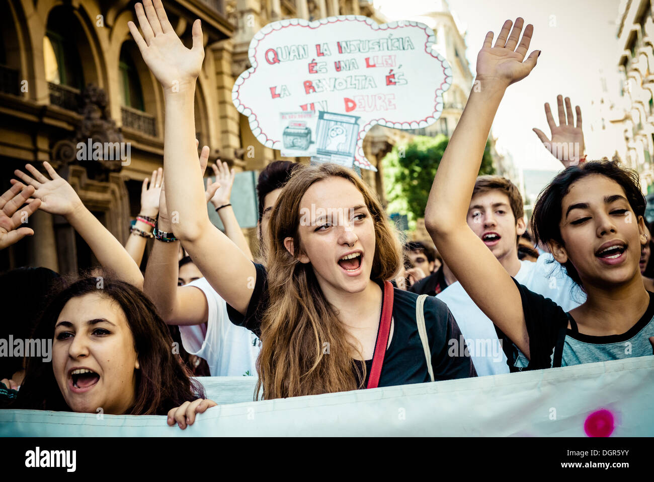 Barcelona, Spain. October 24th, 2013: Students behind their banner shout slogans to protest austerity measures and the 'law Wert' during a three day long education strike in Barcelona. © matthi/Alamy Live News Stock Photo